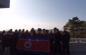 Our tourgroup holding a North Korean flag at the DMZ